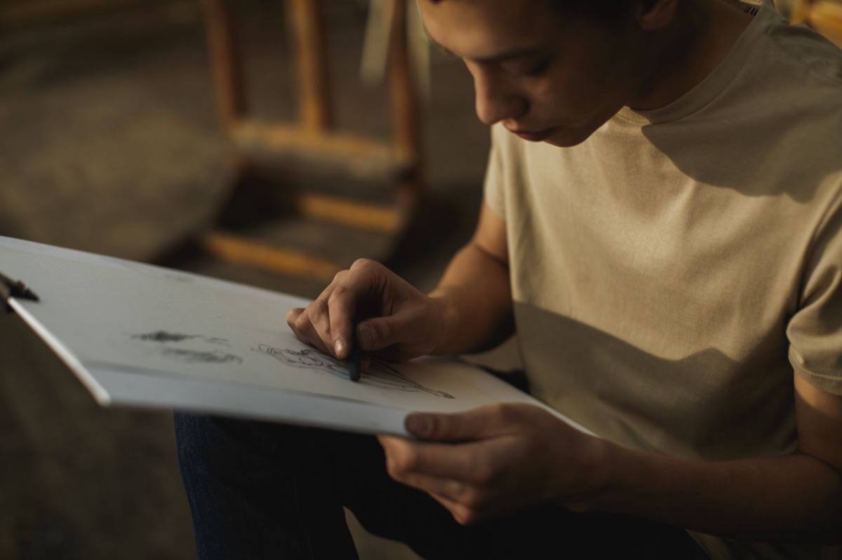 Italian comic artist drawing in a studio