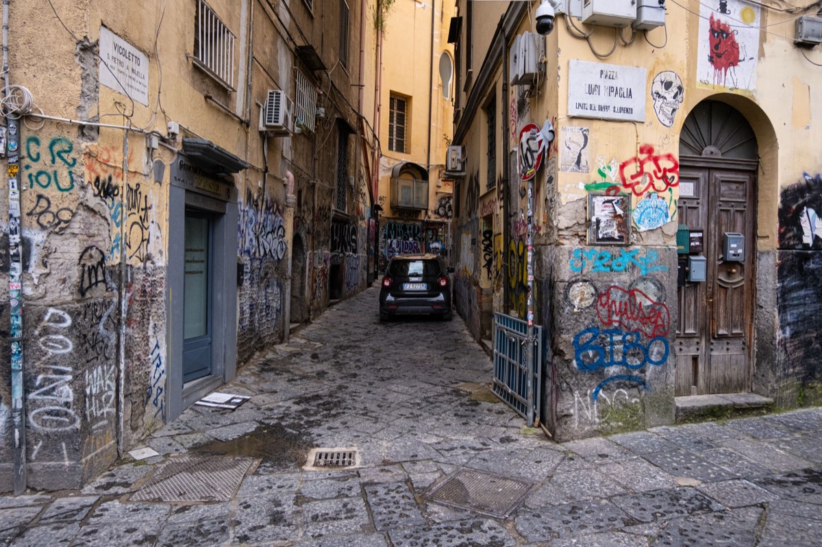 Italian street with chalk drawing of 'Asia vs Italy'