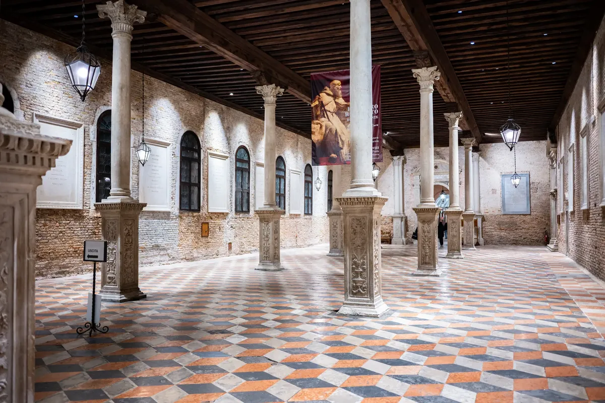 Explore this stunning Venetian interior featuring intricate columns and patterned flooring in Venice, Italy.